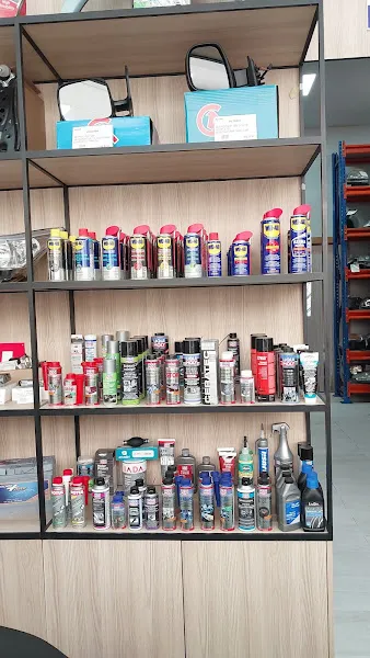 Estantería con botes y sprays de lubricantes y limpiadores en un taller recicla andalucia