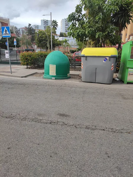 Contenedores en la acera para reciclaje de todo hasta de aceite junto a un paso de peatones